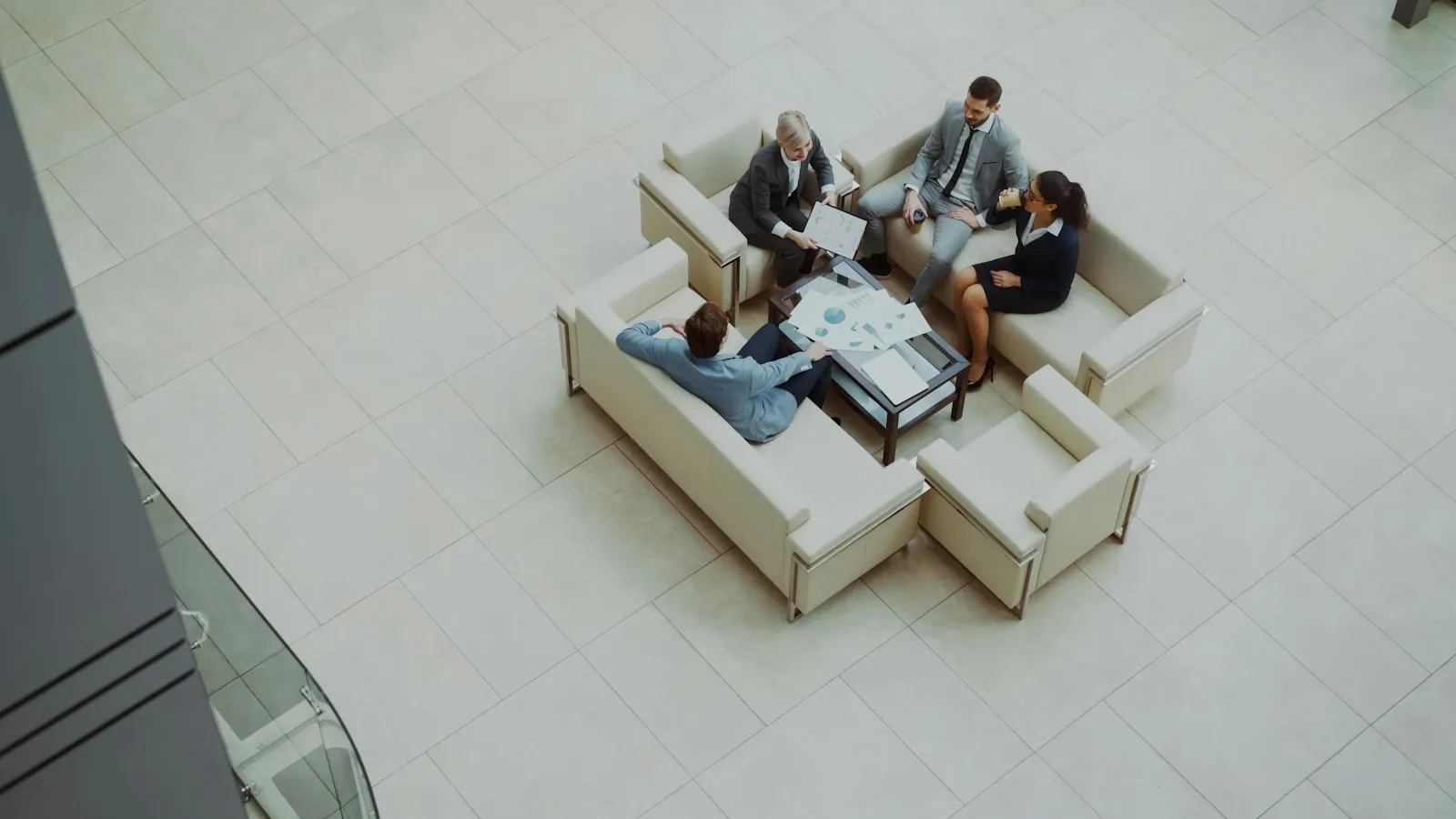Business professionals having a conversation in an office lounge