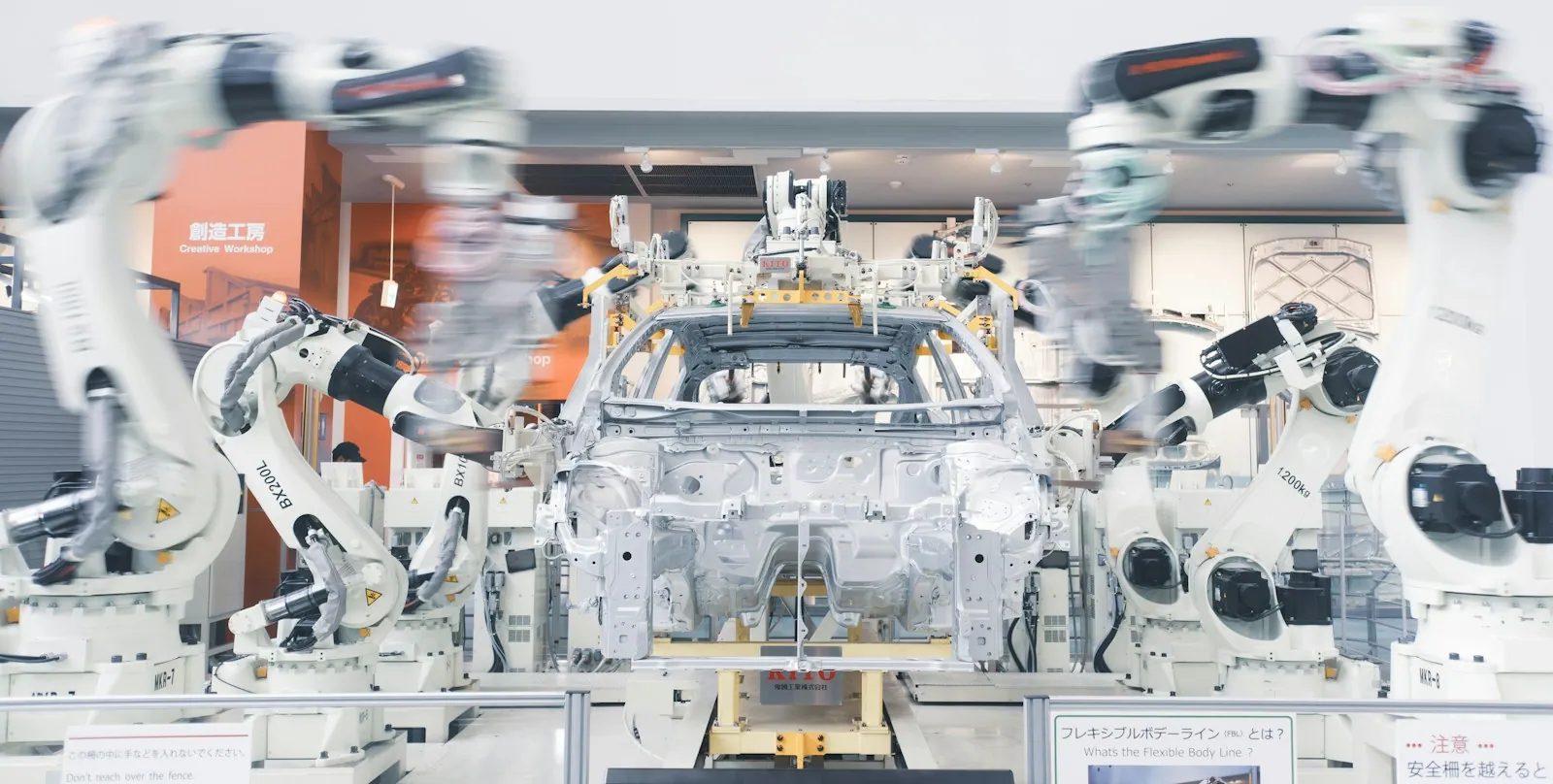 Industrial robotic arms working around an automotive chassis