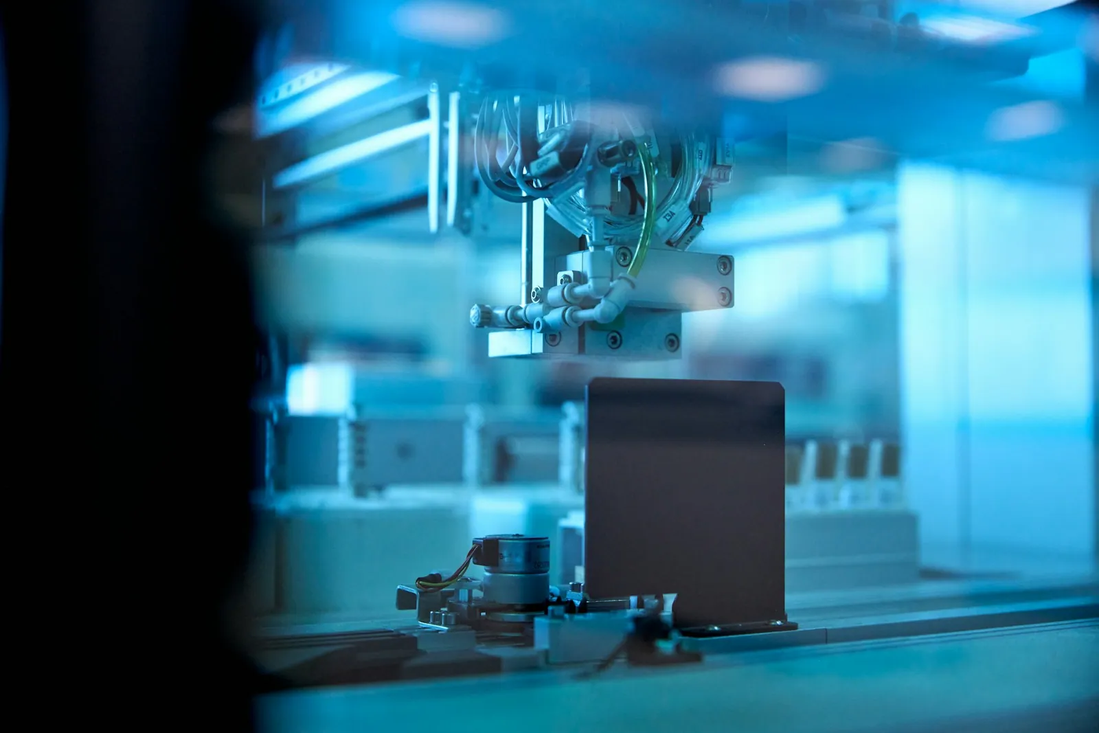 Blue-lit automated sample-processing equipment in a laboratory