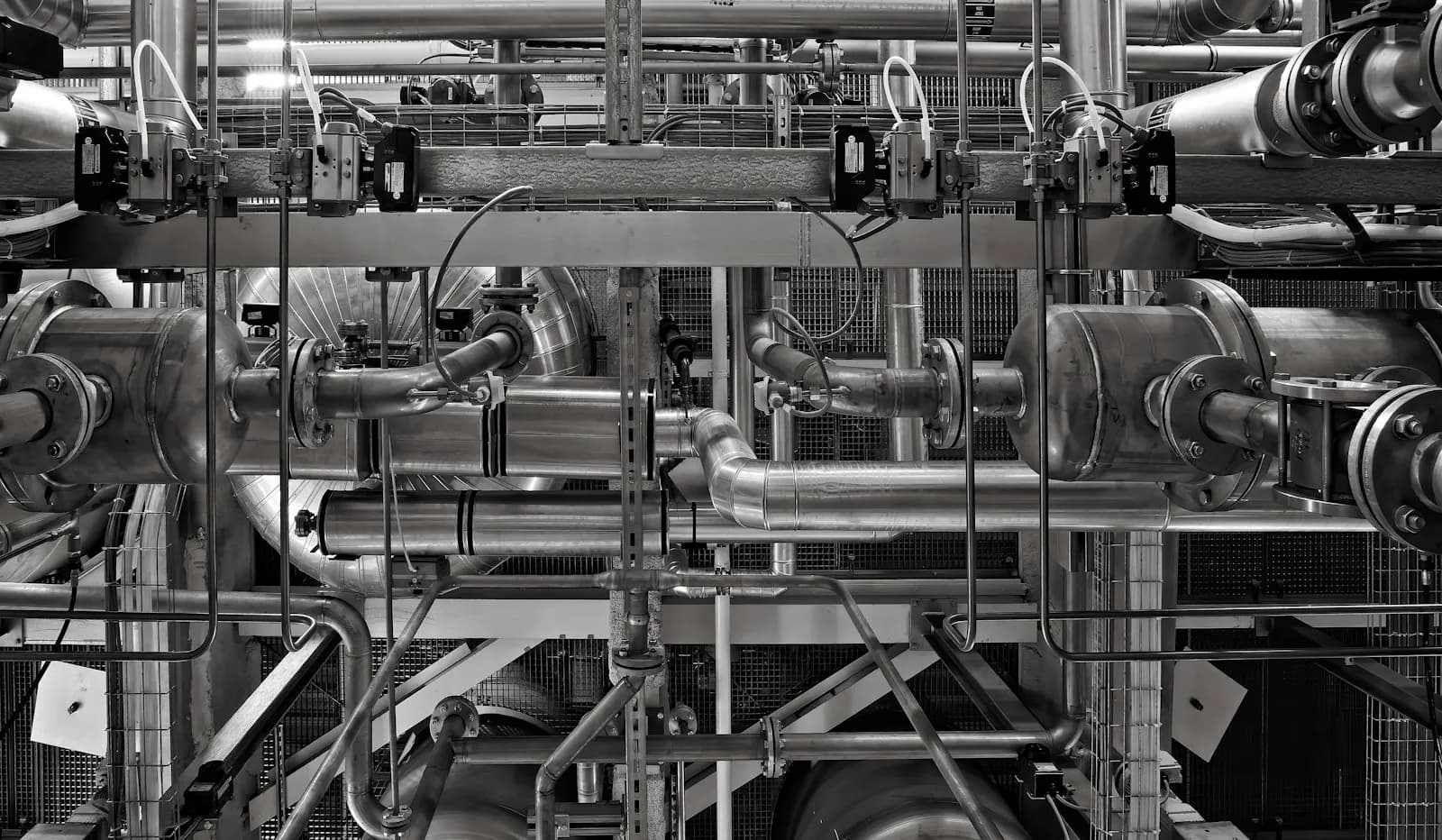 An interconnected network of industrial metal pipes and valves