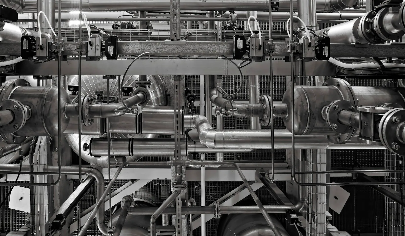 An interconnected network of industrial metal pipes and valves