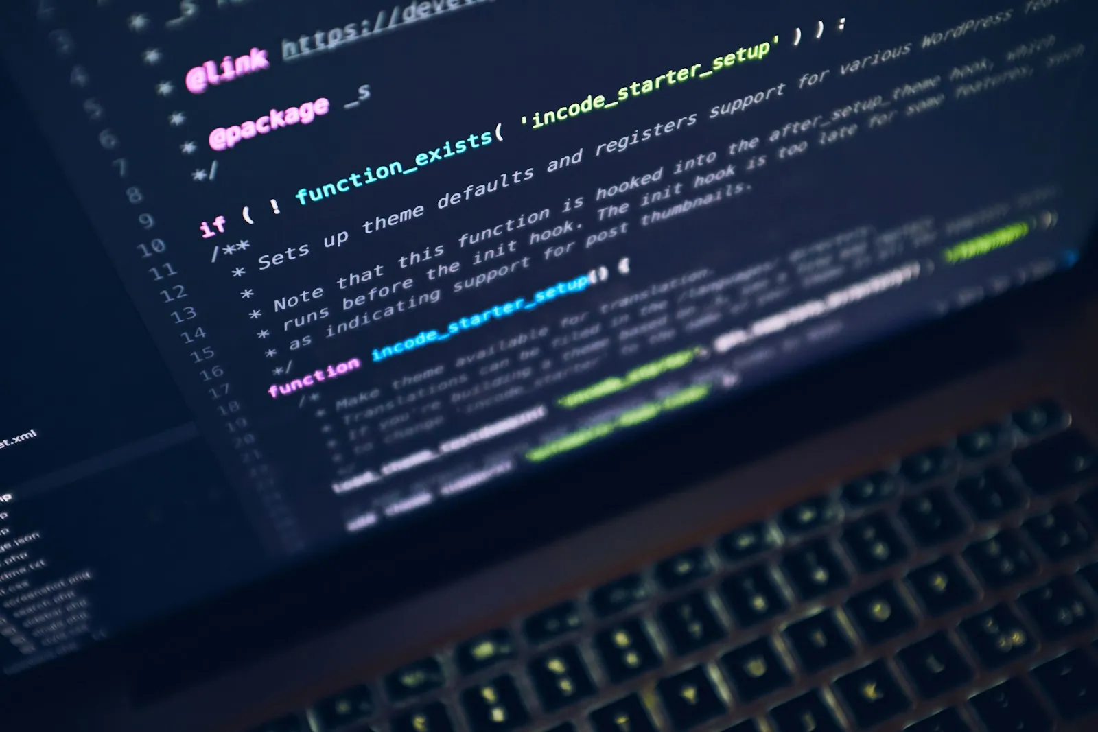 A development laptop and working materials on a desk